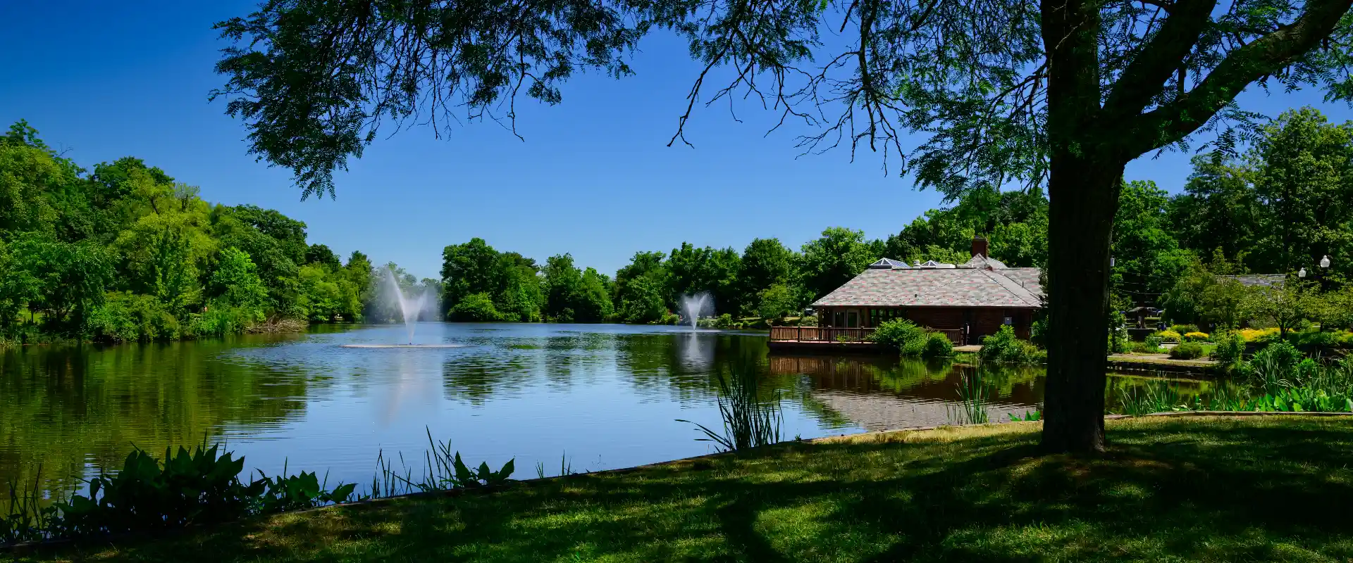 Verona Park lake with fountains and the boathouse on a bright summer day